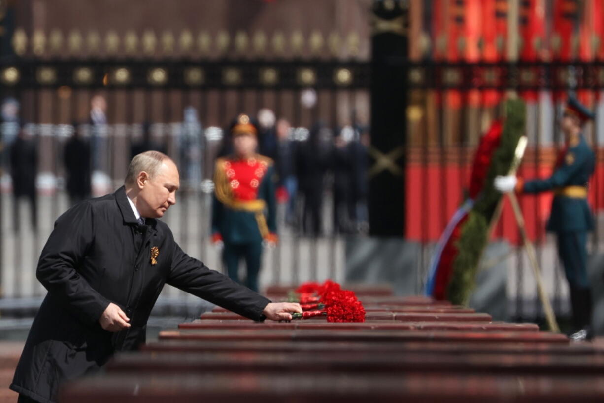 Russian President Vladimir Putin attends a wreath-laying ceremony at the Tomb of the Unknown Soldier after the military parade marking the 77th anniversary of the end of World War II in Moscow, Russia, Monday, May 9, 2022.