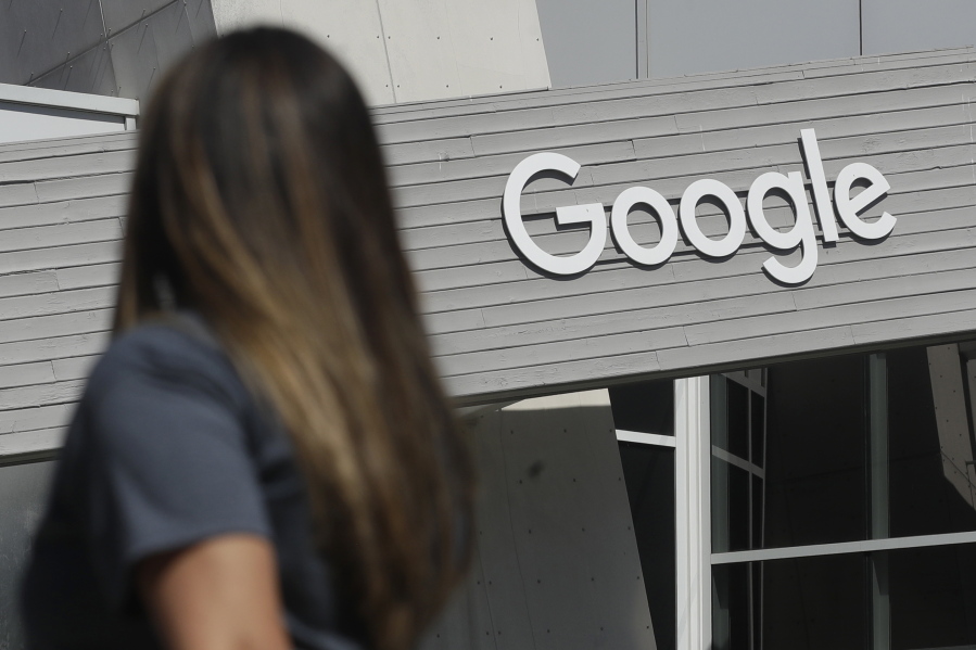 FILE - A woman walks below a Google sign on the campus in Mountain View, Calif., on Sept. 24, 2019. For myriad reasons, both political and philosophical, data privacy laws in the U.S. have lagged far behind those adopted in Europe in 2018.