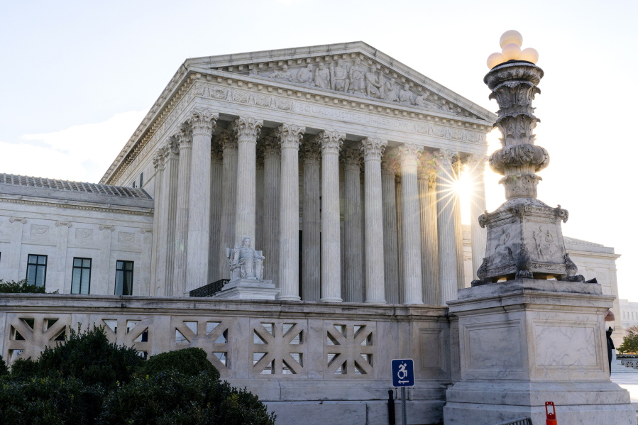 FILE - The sun rises behind the U.S. Supreme Court in Washington, on Nov. 10, 2020. The federal government is warning law enforcement agencies around the nation of the increased potential for extremist violence following the leak of a draft Supreme Court opinion striking down the constitutional right to abortion.