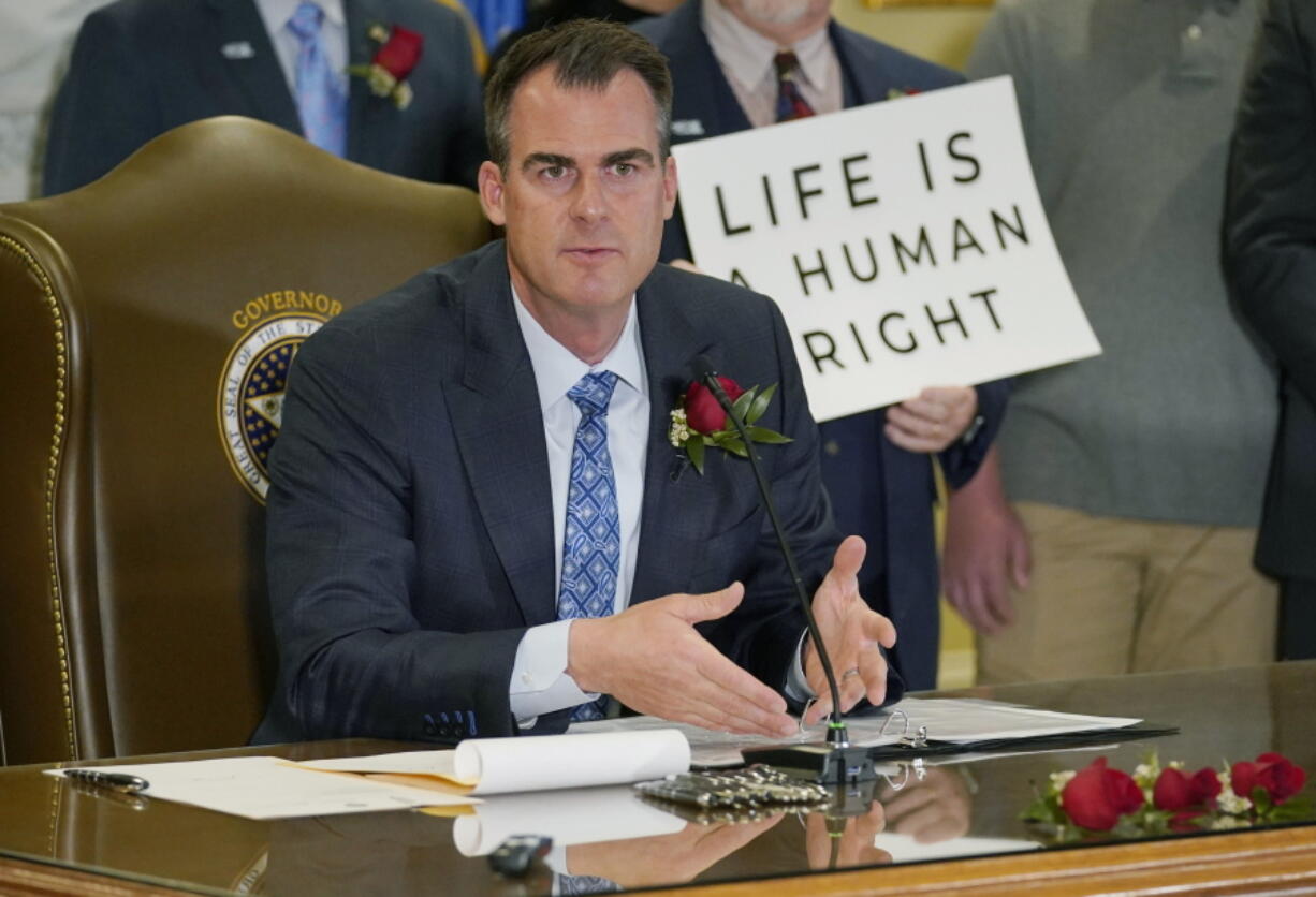 FILE - Oklahoma Gov. Kevin Stitt speaks after signing into law a bill making it a felony to perform an abortion, punishable by up to 10 years in prison, on. April 12, 2022, in Oklahoma City. Stitt on Wednesday, May 25 signed into law the nation's strictest abortion ban, making the state the first in the nation to effectively end availability of the procedure. State lawmakers approved the ban enforced by civil lawsuits rather than criminal prosecution, similar to a Texas law that was passed last year.