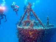 Divers swim near the bow of the retired Naval Landing Ship Dock Spiegel Grove, sunk 20 years earlier, six miles off Key Largo, Fla., to become an artificial reef.