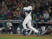 Seattle Mariners' Kyle Lewis watches his a solo home run against the Houston Astros during the second inning of a baseball game, Saturday, May 28, 2022, in Seattle. (AP Photo/Ted S.