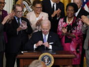 President Joe Biden signs an executive order in the East Room of the White House, Wednesday, May 25, 2022, in Washington. The order comes on the second anniversary of George Floyd's death, and is focused on policing.