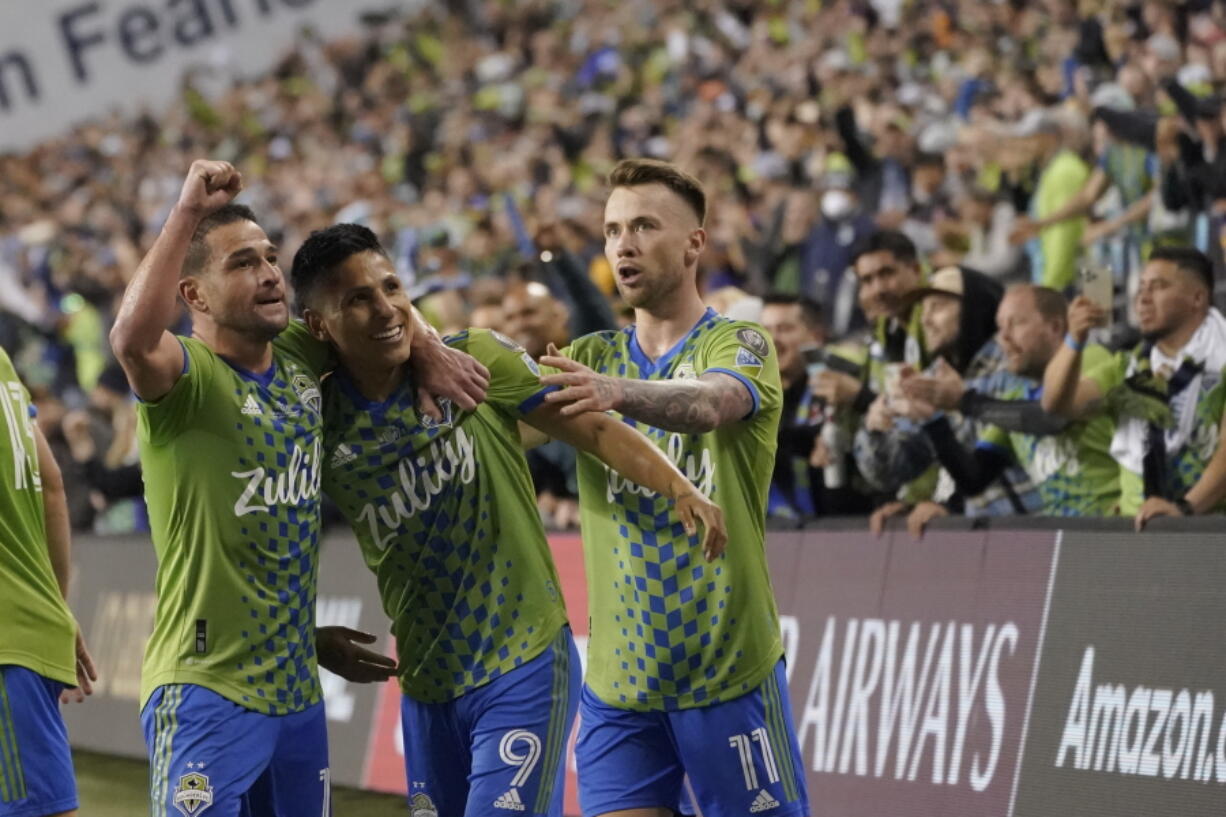 United States' Seattle Sounders forward Raul Ruidiaz (9) celebrates his goal with teammates during the second half of the second leg of the CONCACAF Champions League soccer final against Mexico's Pumas, Wednesday, May 4, 2022, in Seattle. (AP Photo/Ted S.