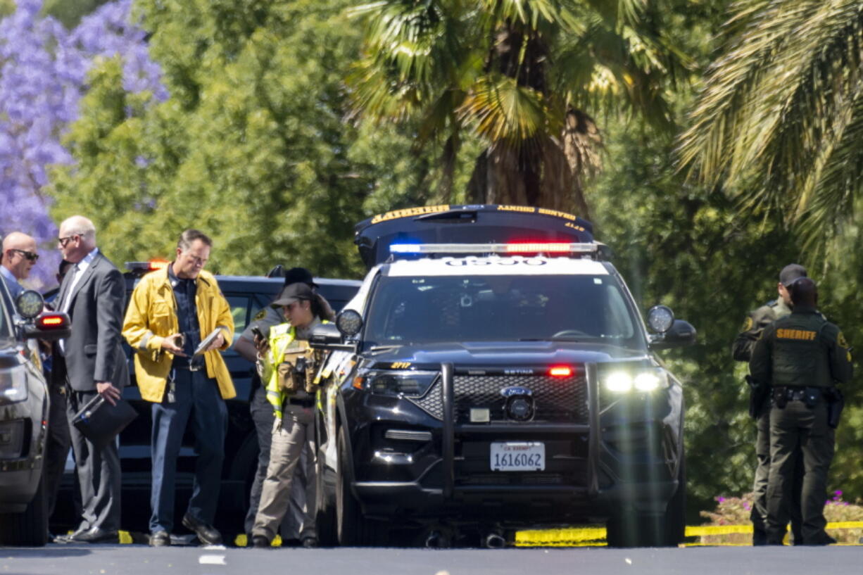 Investigators gather outside the Geneva Presbyterian Church in Laguna Woods, Calif., on Sunday, May 15, 2022 after a fatal shooting.