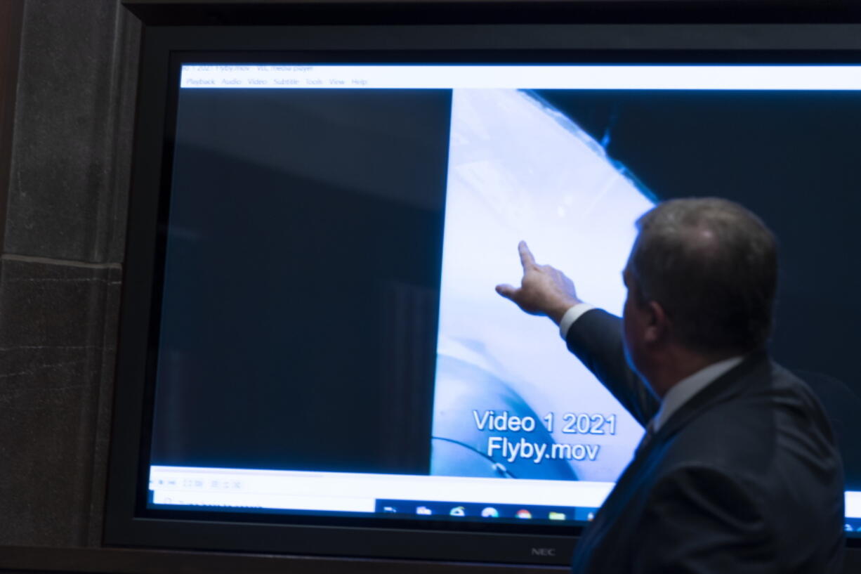 Deputy Director of Naval Intelligence Scott Bray points to a video display of a UAP during a hearing of the House Intelligence, Counterterrorism, Counterintelligence, and Counterproliferation Subcommittee hearing on "Unidentified Aerial Phenomena," on Capitol Hill, Tuesday, May 17, 2022, in Washington.