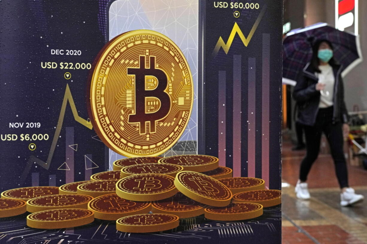 FILE - An advertisement for Bitcoin cryptocurrency is displayed on a street in Hong Kong, Thursday, Feb. 17, 2022. It's been a wild week in crypto, even by crypto standards. Bitcoin tumbled, stablecoins were anything but stable and one of the crypto industry's highest-profile companies lost a third of its market value.