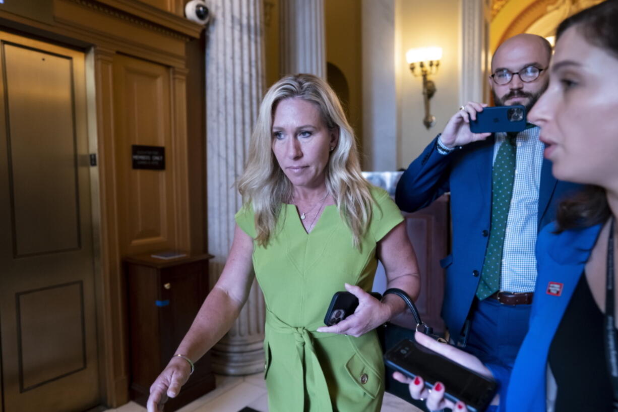 FILE - Rep. Marjorie Taylor Greene, R-Ga., departs the House chamber at the end of votes, at the Capitol in Washington, May 12, 2022. Greene is testing Republican voters' tolerance for controversy in the May 24, 2022, Republican primary. (AP Photo/J.