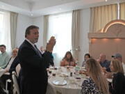 Rabbi Elie Abadie says a blessing as he hosts a lunch for a Jewish business delegation at a villa that serves as a temporary synagogue for his congregation in Dubai, United Arab Emirates, Tuesday, May 10, 2022. The fast-growing population of Jewish immigrants to the United Arab Emirates may feel freer than ever to express their identity in the autocratic Arab sheikhdom, which has sought to brand itself as an oasis of religious tolerance. But plans to build a permanent Jewish sanctuary for Dubai's fast-expanding congregation have sputtered to a standstill, religious leaders say.