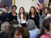 Former members and members of the U.S. Women's National soccer team, from left,  Briana Scurry, Margaret 'Midge' Purce, Kelley O'Hara, Julie Foudy, and Cindy Parlow Cone, President of U.S. Soccer, pose for a photo with House Speaker Nancy Pelosi of Calif., before an event to celebrate Equal Pay Day and Women's History Month in the East Room of the White House, Tuesday, March 15, 2022, in Washington. The U.S. Soccer Federation reached milestone agreements to pay its men's and women's teams equally, making the American national governing body the first in the sport to promise both sexes matching money.