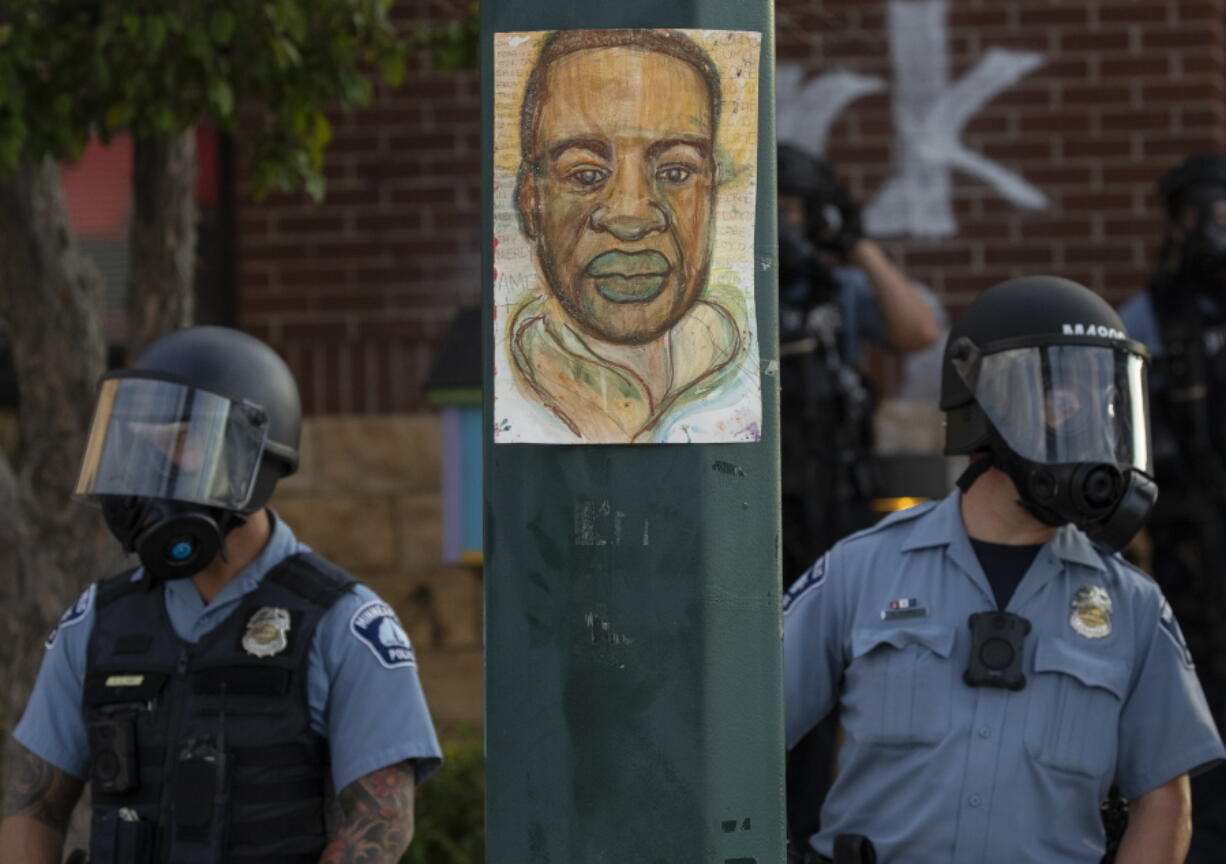 FILE - Minneapolis police stand outside the department's 3rd Precinct on May 27, 2020, in Minneapolis. President Joe Biden plans to sign an executive order on policing on Wednesday, the second anniversary of George Floyd's death. That's according to three people familiar with the matter who spoke on condition of anonymity to preview the matter. The executive order includes changes to policies on use of force and restrictions on the flow of surplus military hardware to local police.