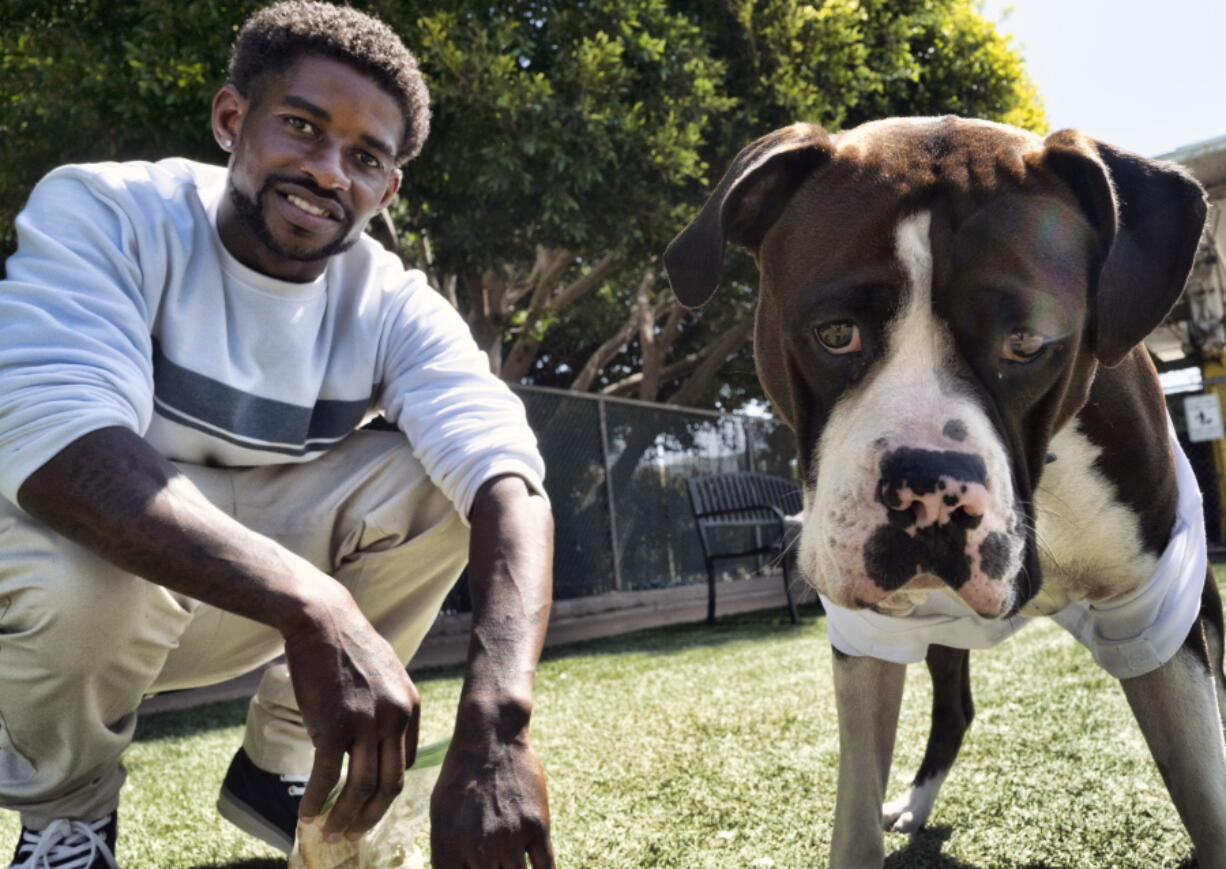 Ro Mantooth plays with his dog, Champ, at a dog park with the nonprofit People Assisting the Homeless, in the Venice section of Los Angeles on Tuesday, April 5, 2022. It was the first facility of its kind in Los Angeles County to allow homeless shelter residents to bring animal companions. "He's really my best friend. I don't know what I'd do without him," Mantooth, 29, said of Champ. "I'm lucky to have him.