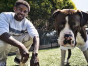 Ro Mantooth plays with his dog, Champ, at a dog park with the nonprofit People Assisting the Homeless, in the Venice section of Los Angeles on Tuesday, April 5, 2022. It was the first facility of its kind in Los Angeles County to allow homeless shelter residents to bring animal companions. "He's really my best friend. I don't know what I'd do without him," Mantooth, 29, said of Champ. "I'm lucky to have him.