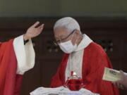 Retired archbishop of Hong Kong Joseph Zen, attends the episcopal ordination ceremony of Bishop Stephen Chow, in Hong Kong, Saturday, Dec. 4, 2021. Zen, the 90-year-old Catholic cleric arrested by Hong Kong police on national security charges, has long been a fiery critic of Beijing, along with efforts by the Vatican to reach a working arrangement with the ruling Communist Party.