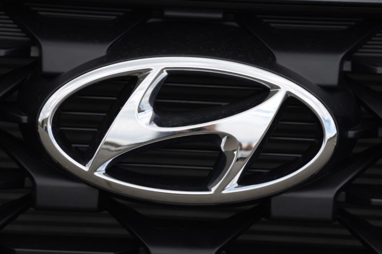 FILE - The Hyundai logo shines off the grille of an unsold vehicle at a Hyundai dealership Sunday, Sept. 12, 2021, in Littleton, Colo.  Hyundai is recalling more than 215,000 midsize cars in the U.S., Wednesday, May 11, 2022,  most for a second time -- because fuel hoses can leak in the engine compartment and cause fires. The recall covers certain 2013 and 2014 Sonata sedans, many of which were recalled for the same problem in 2020.