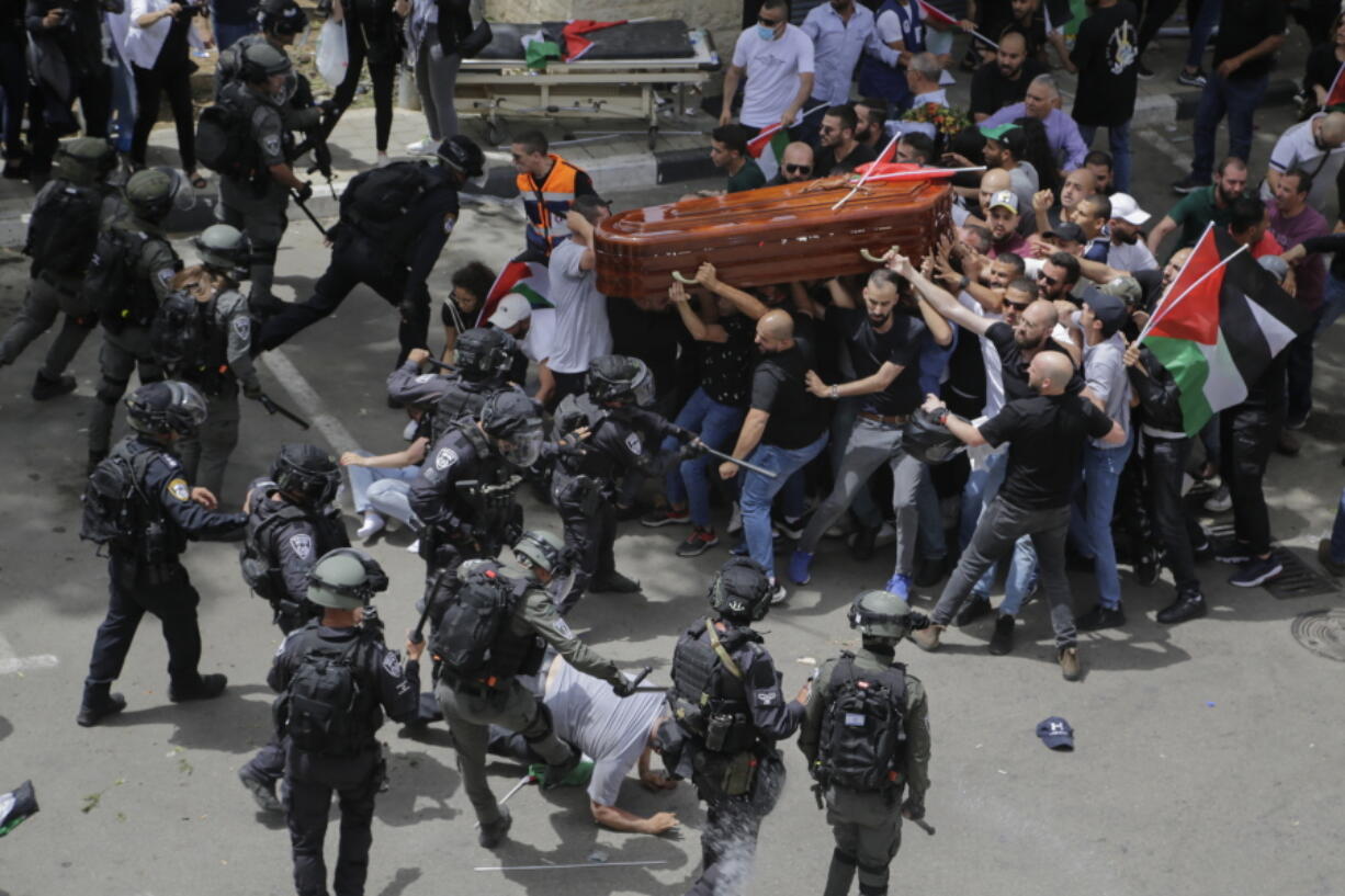 FILE - Israeli police confront mourners as they carry the casket of slain Al Jazeera veteran journalist Shireen Abu Akleh during her funeral in east Jerusalem, Friday, May 13, 2022. Latin Patriarch Pierbattista Pizzaballa, the top Catholic clergyman in the Holy Land, told reporters at St. Joseph Hospital in Jerusalem on Monday that the police beating mourners as they carried Shireen Abu Akleh's her casket was a disproportionate use of force that "disrespected" the Catholic Church. He added that Israel committed a "severe violation" of international norms.