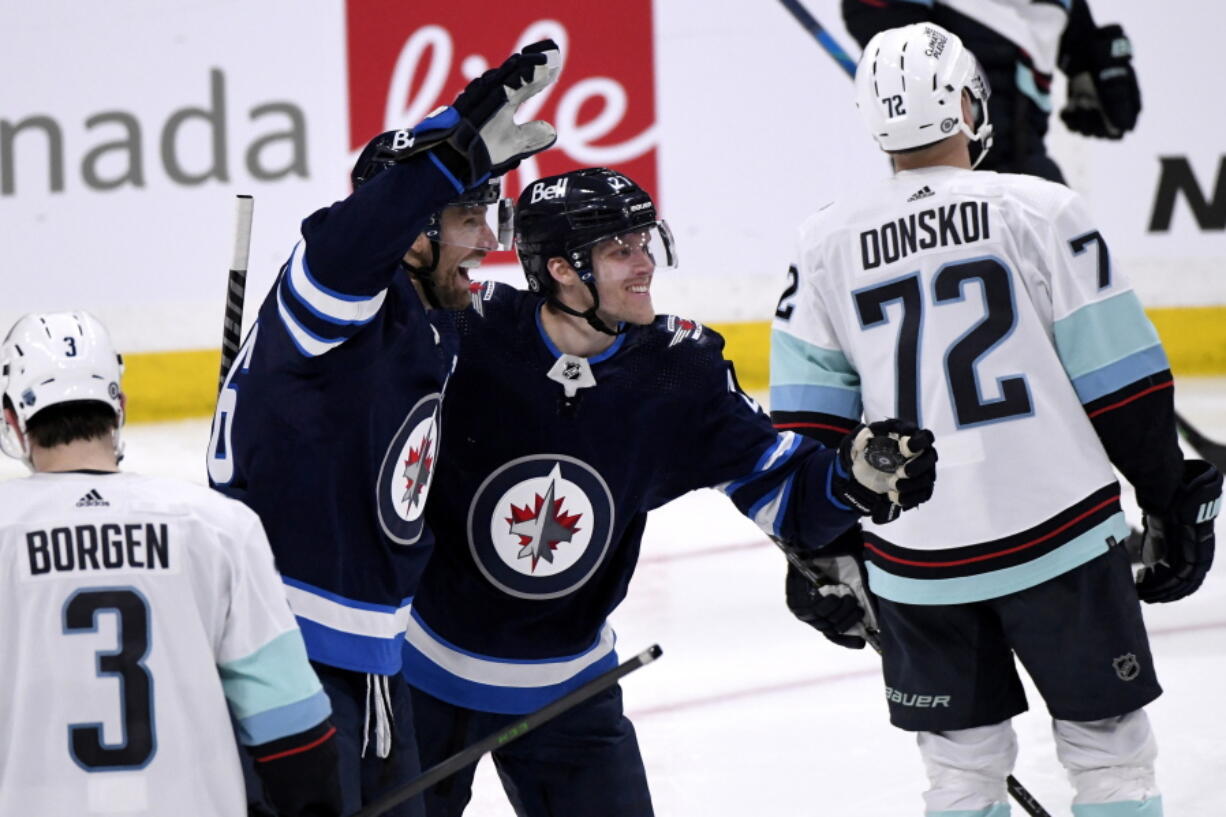 Winnipeg Jets' Blake Wheeler (26) celebrates his goal against the Seattle Kraken with Nikolaj Ehlers (27) during the third period of NHL hockey game action in Winnipeg, Manitoba, Sunday, May 1, 2022.