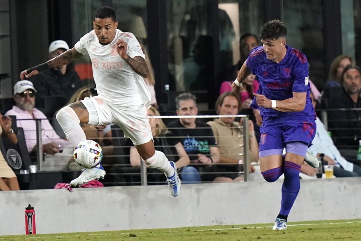 Inter Miami midfielder Gregore, left, runs with the ball as Portland Timbers defender Justin Rasmussen gives chase during the second half of an MLS soccer match, Saturday, May 28, 2022, in Fort Lauderdale, Fla. Inter Miami won 2-1.