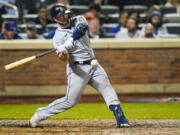 Seattle Mariners' Ty France hits an RBI single during the eighth inning of a baseball game against the New York Mets Friday, May 13, 2022, in New York.