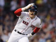 Boston Red Sox's Trevor Story looks to the dugout after hitting a grand slam against the Seattle Mariners during the third inning of a baseball game Friday, May 20, 2022, in Boston.