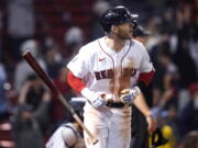 Boston Red Sox's Trevor Story tosses his bat while watching his three-run home run against the Seattle Mariners during the eighth inning of a baseball game at Fenway Park, Thursday, May 19, 2022, in Boston. Story hit two two-run home runs earlier in the game.