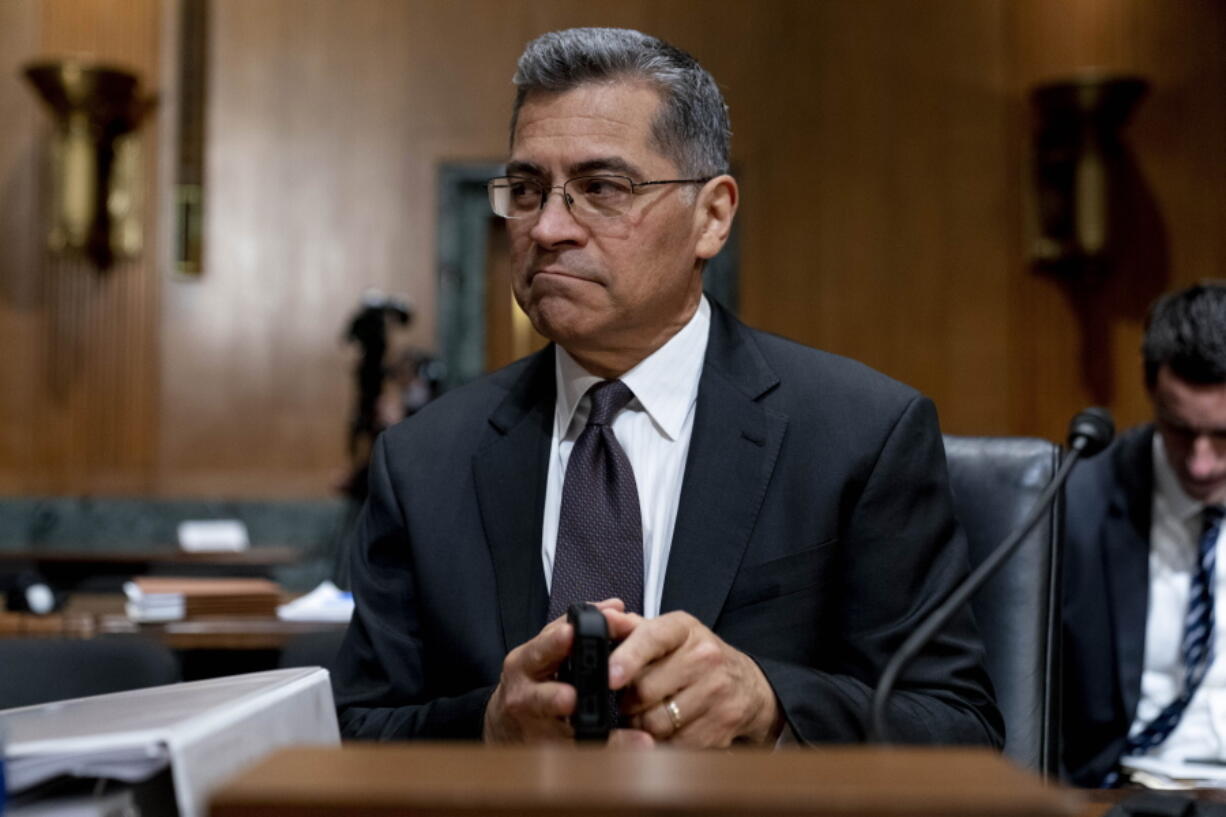 FILE - Health and Human Services Secretary Xavier Becerra arrives for a hearing on Capitol Hill in Washington, April 5, 2022. Medicare recipients will get a premium reduction -- but not until next year. That reflects what Becerra says was an overestimate in costs of covering a costly and controversial new Alzheimer's drug.