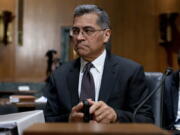 FILE - Health and Human Services Secretary Xavier Becerra arrives for a hearing on Capitol Hill in Washington, April 5, 2022. Medicare recipients will get a premium reduction -- but not until next year. That reflects what Becerra says was an overestimate in costs of covering a costly and controversial new Alzheimer's drug.