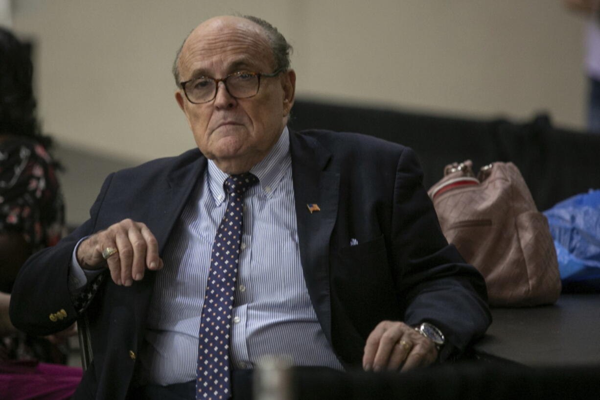 Former New York City Mayor Rudy Giuliani sits where delegate votes will be counted as nominee for statewide positions are introduced during the Michigan Republican convention at Devos Place in Grand Rapids, Mich., on Saturday, April 23, 2022.