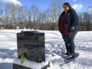 FILE - Deb Walker visits the grave of her daughter, Brooke Goodwin, Thursday, Dec. 9, 2021, in Chester, Vt. Goodwin, 23, died in March of 2021 of a fatal overdose of the powerful opioid fentanyl and xylazine, an animal tranquilizer that is making its way into the illicit drug supply. According to provisional data released by the Centers for Disease Control and Prevention on Wednesday, May 11, 2022, more than 107,000 Americans died of drug overdoses in 2021, setting another tragic record in the nation's escalating overdose epidemic.