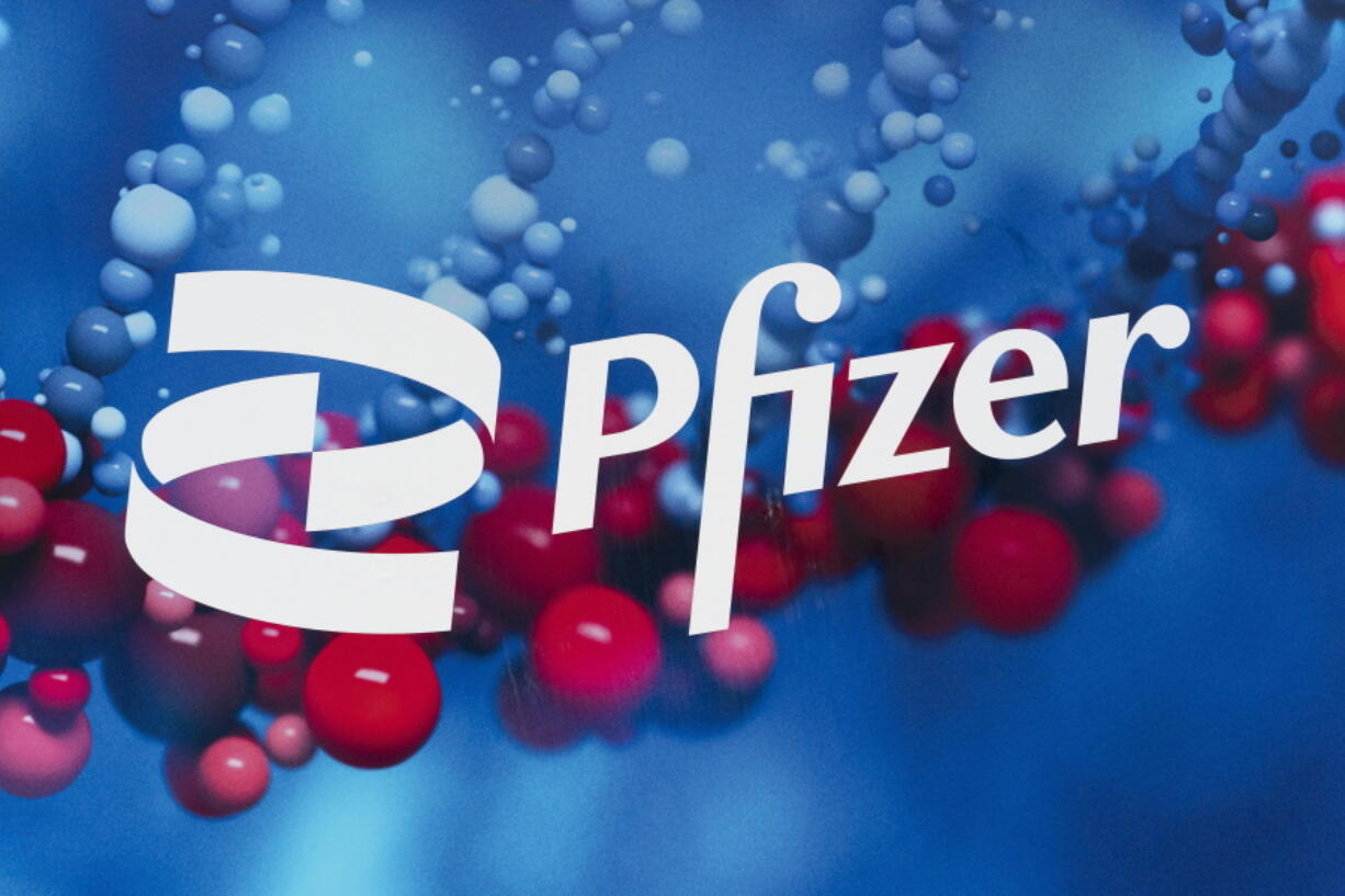 The Pfizer logo is displayed at the company's headquarters, Feb. 5, 2021, in New York. Sales of Pfizer's COVID-19 vaccine and treatment pushed the drugmaker well past expectations in the first quarter, as profit grew 61%.