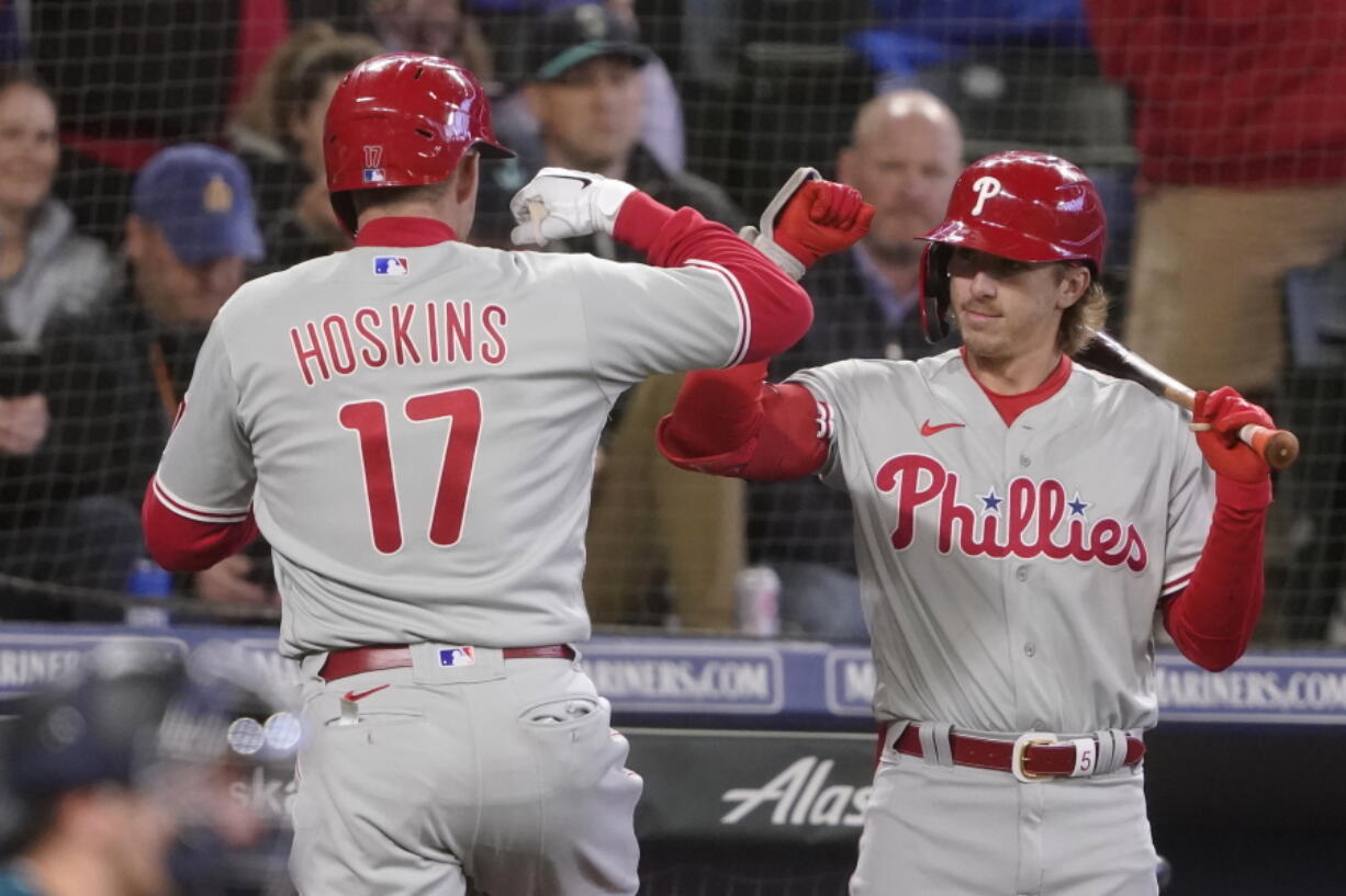 Philadelphia Phillies' Rhys Hoskins (17) is greeted by Bryson Stott, right, after hitting a solo home run against the Seattle Mariners, Monday in Seattle. (Ted S.