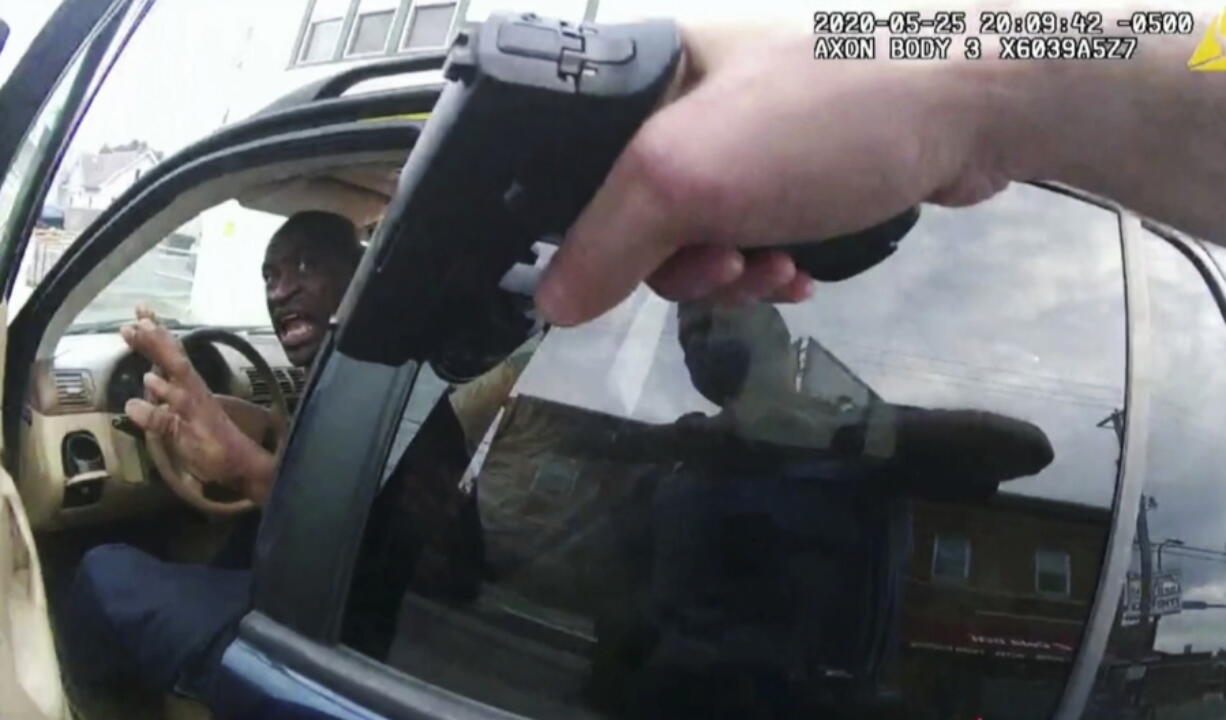 FILE - In this May 25, 2020, file pool photo from police body camera video, George Floyd responds to police after they approached his car outside Cup Foods in Minneapolis. The Minneapolis Police Department is expected to face the intense scrutiny of a federal program credited with significant reform in some places, but scorned by critics in others as ineffective and a waste of taxpayer money. An investigation spurred by the killing of Floyd found that Minneapolis officers stopped and arrested Black people at a higher rate than white people, used force more often on people of color and maintained a culture where racist language was tolerated.