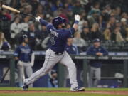 Tampa Bay Rays' Mike Zunino follows through on a three-run home run during the fourth inning of the team's baseball game against the Seattle Mariners, Thursday, May 5, 2022, in Seattle. (AP Photo/Ted S.