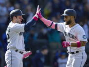 Seattle Mariners' Abraham Toro, right, is greeted at home plate by Luis Torrens after hitting a solo home run against the Tampa Bay Rays during the ninth inning of a baseball game, Sunday, May 8, 2022, in Seattle.