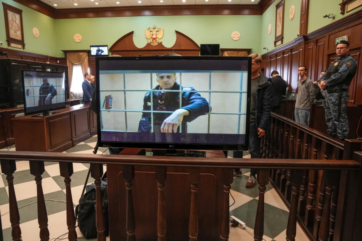 Russian opposition leader Alexei Navalny appears on a screen set up at a court room of the Moscow City Court via a video link from his prison colony provided by the Russian Federal Penitentiary Service during a hearing of an appeal against his nine-year prison sentence in Moscow, Russia, Tuesday, May 24, 2022. A Russian court has rejected Navalny's appeal of a nine-year prison sentence for fraud.