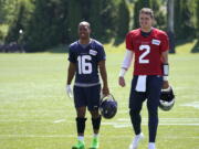 Seattle Seahawks quarterback Drew Lock, right, walks with Tyler Lockett after practice Tuesday in Renton. (Ted S.