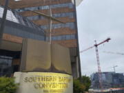 A cross and Bible sculpture stand outside the Southern Baptist Convention headquarters in Nashville, Tenn., on Tuesday, May 24, 2022. On Tuesday, top administrative leaders for the SBC, the largest Protestant denomination in America, said that they will release a secret list of hundreds of pastors and other church-affiliated personnel accused of sexual abuse.