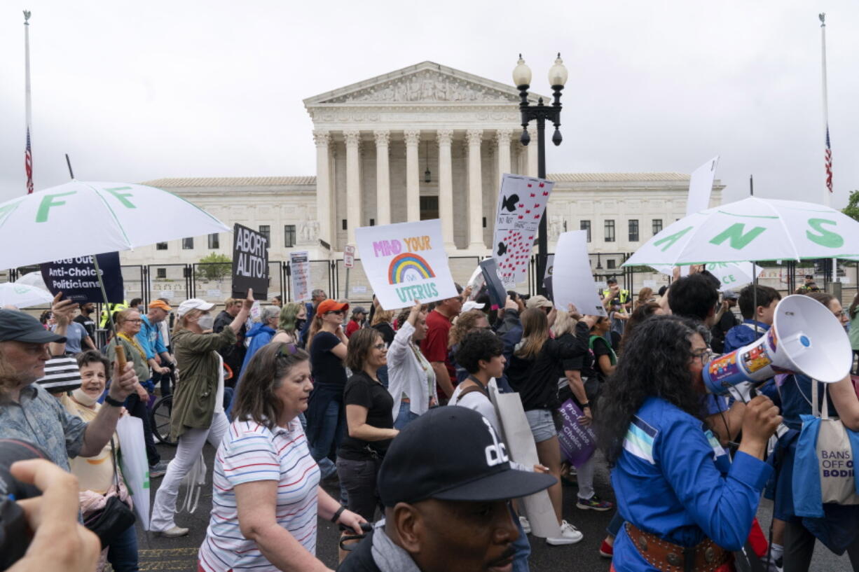 Abortion-rights demonstrators coming from the Washington Monument march past the Supreme Court in Washington, Saturday, May 14, 2022.