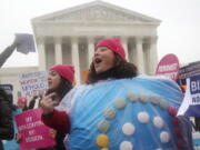 FILE - Margot Riphagen of New Orleans, wears a birth control pill costume as she protests in front of the Supreme Court in Washington on March 25, 2014. In 2022, a leaked draft opinion indicating U.S. Supreme Court justices are poised to overturn the decision that legalized abortion nationwide in the U.S. is raising fears that restrictions on contraception could follow.