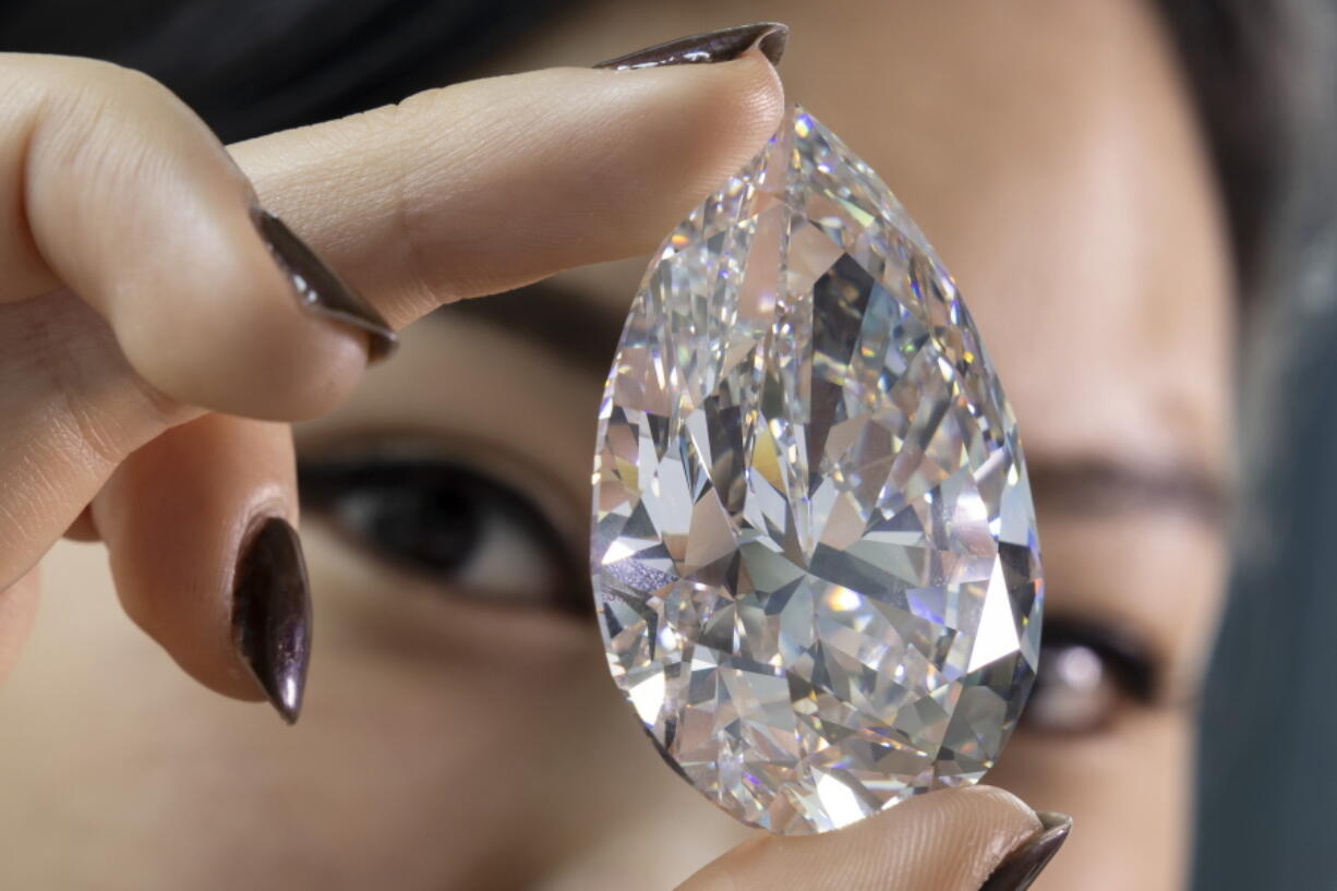 A Christie's employee holds "The Rock" during a preview May 6 at Christie's in Geneva, Switzerland.