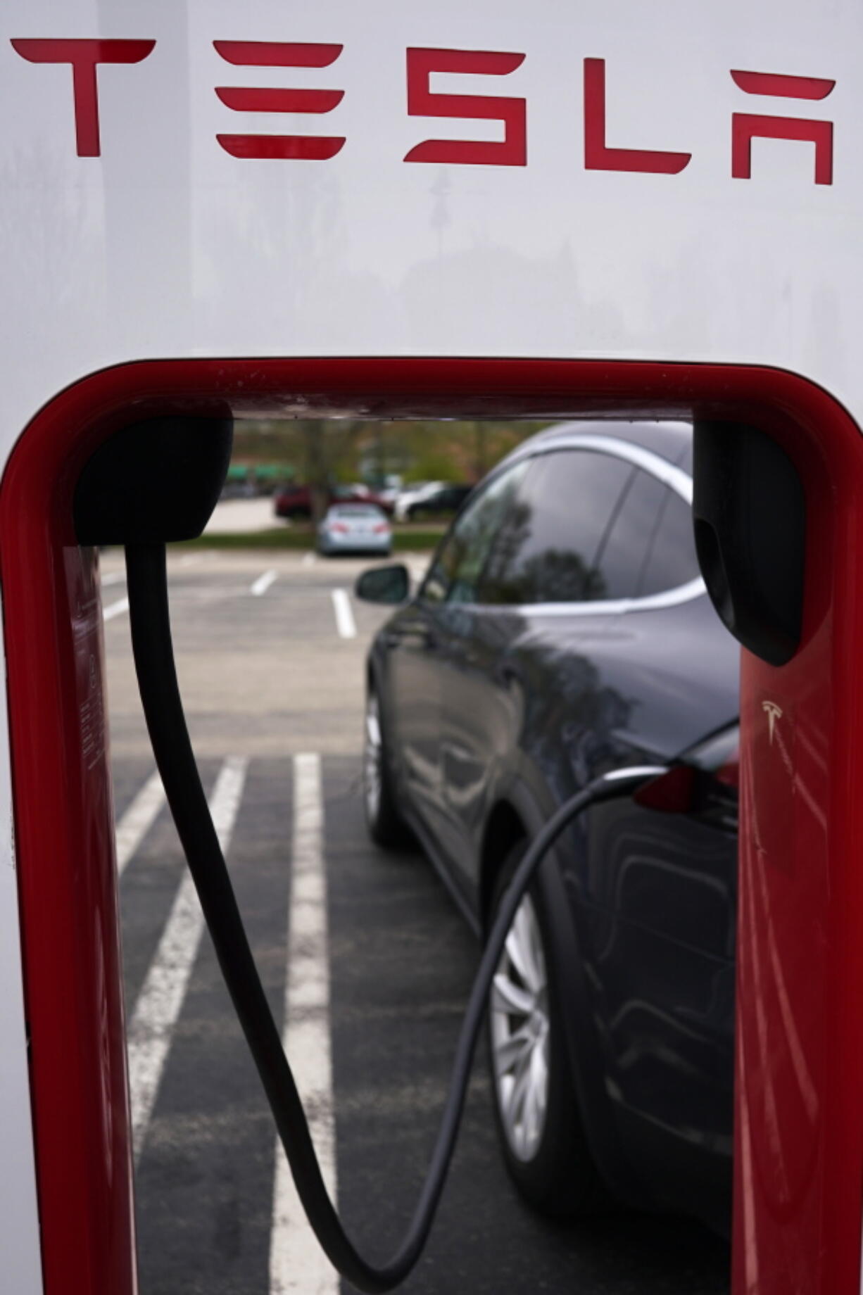 Tesla Supercharger is seen at Willow Festival shopping plaza parking lot in Northbrook, Ill., Thursday, May 5, 2022.  Tesla is recalling about 130,000 vehicles across its U.S. model lineup, Tuesday, May 10,  because the touch screens can overheat and go blank. The recall covers certain Model S sedan and Model X SUVs from 2021 and 2022, as well as Model 3 cars and Model Y SUVs from 2022.   (AP Photo/Nam Y.