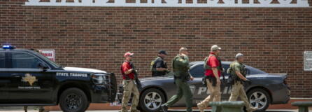 Law enforcement personnel walk outside Uvalde High School after shooting a was reported earlier in the day at Robb Elementary School, Tuesday, May 24, 2022, in Uvalde, Texas.