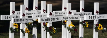 Crosses with the names of Tuesday's shooting victims are placed outside Robb Elementary School in Uvalde, Texas, Thursday, May 26, 2022. The 18-year-old man who slaughtered 19 children and two teachers in Texas left a digital trail that hinted at what was to come.  (AP Photo/Jae C.