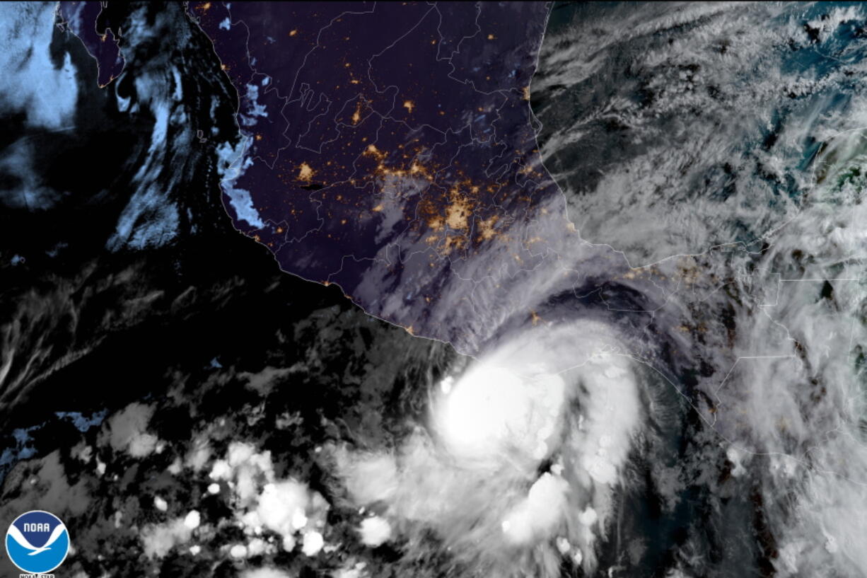 This satellite image made available by NOAA shows Hurricane Agatha off the Pacific coast of Oaxaca state, Mexico on Monday, May 30, 2022, at 8:30 a.m. EDT.