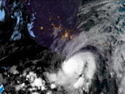 This satellite image made available by NOAA shows Hurricane Agatha off the Pacific coast of Oaxaca state, Mexico on Monday, May 30, 2022, at 8:30 a.m. EDT.