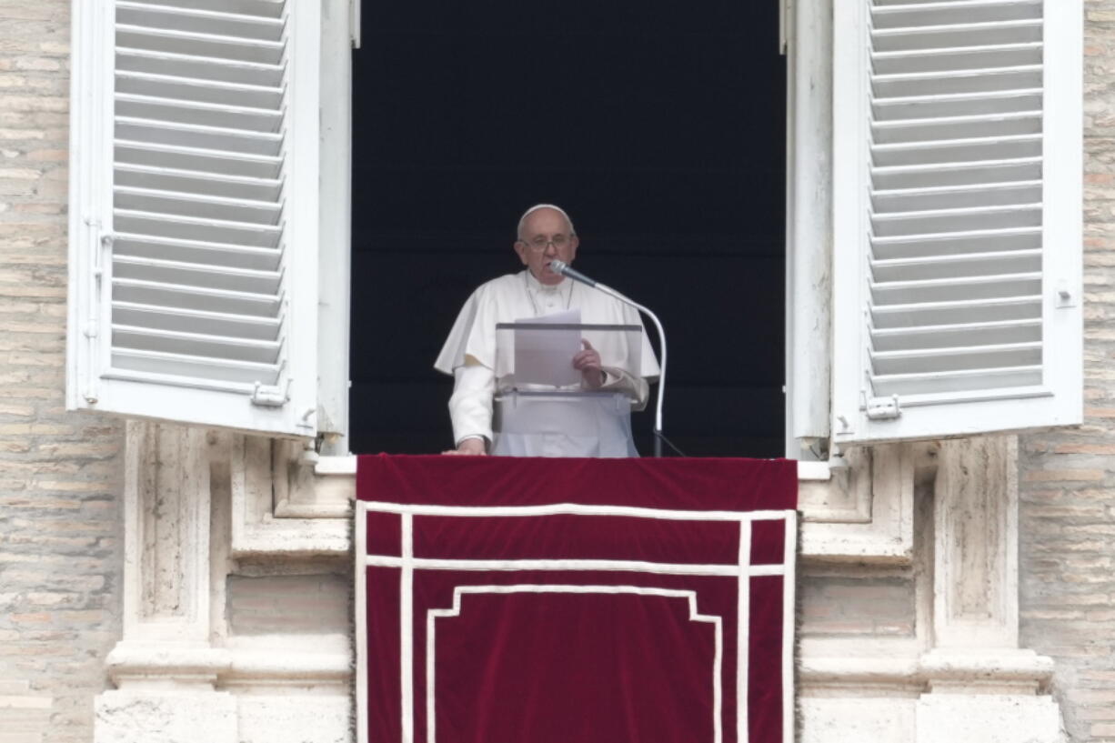 Pope Francis delivers his message from his studio window overlooking St. Peter's Square during the Regina Coeli prayer at the Vatican, Sunday, May 1, 2022.