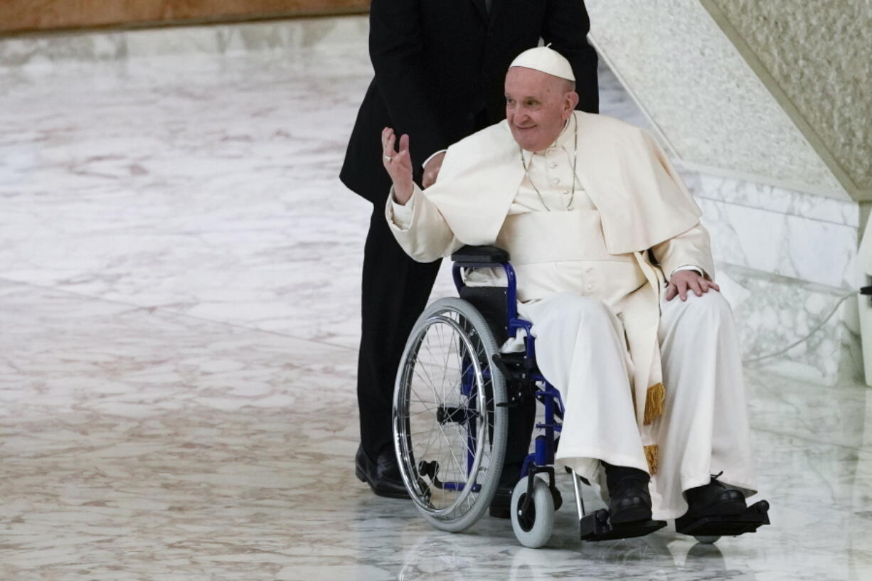 FILE - Pope Francis arrives in a wheelchair to attend an audience with nuns and religious superiors in the Paul VI Hall at The Vatican, Thursday, May 5, 2022. Pope Francis, whose mobility has been limited of late by a nagging knee problem, is looking forward to visiting South Sudan in July, according to a joint message by the pontiff, the archbishop of Canterbury and a Scottish church official.