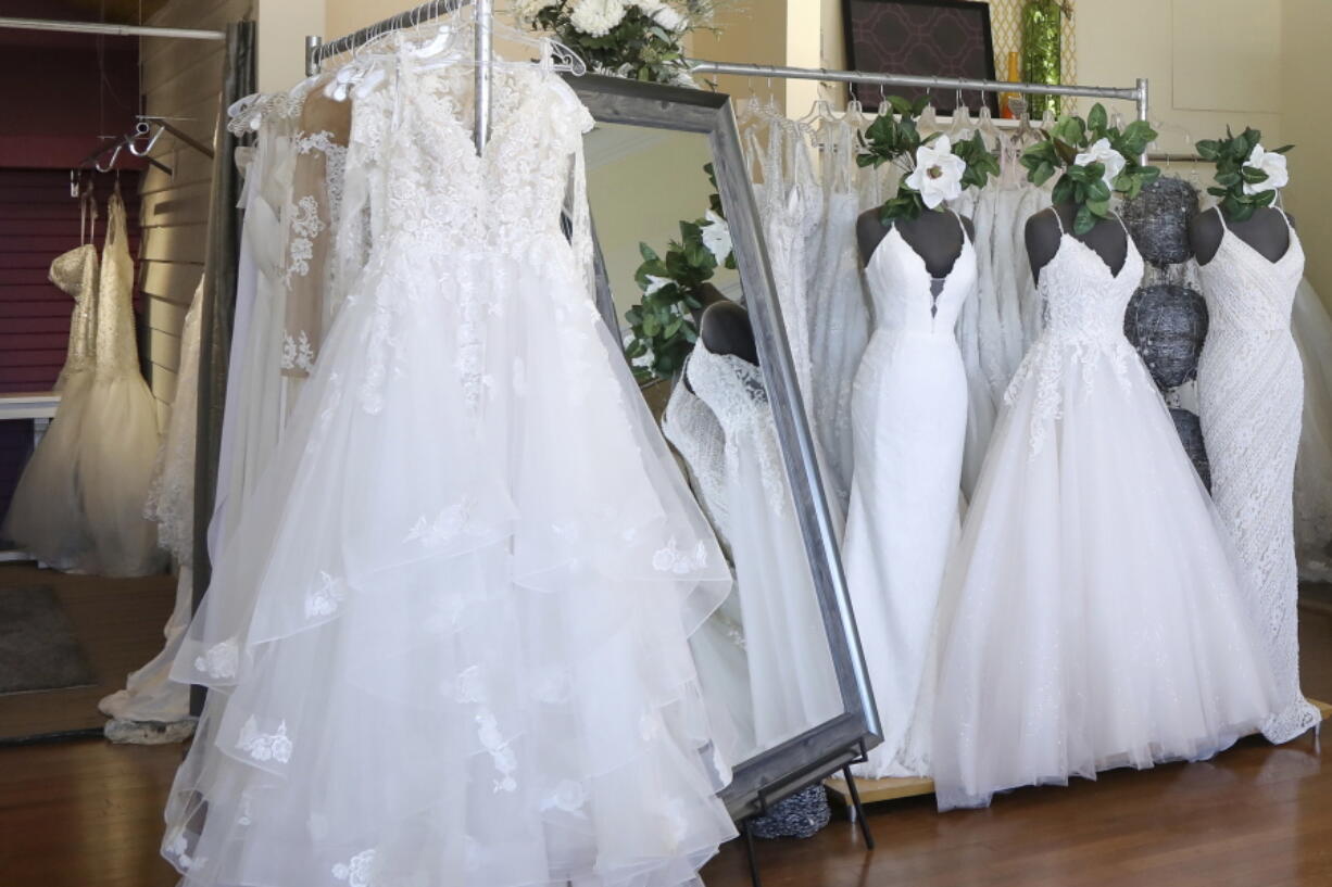 FILE - Wedding dresses are displayed at a bridal shop in East Dundee, Ill., on Feb. 28, 2020. Far fewer Americans were married during the first year of the COVID-19 pandemic, with the number of U.S. marriages in 2020 being the lowest recorded since 1963, according to statistics released by the Centers for Disease Control and Prevention on Tuesday, May 17, 2022.