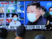 People watch a TV screen showing a news program reporting with an image of North Korean leader Kim Jong Un, at a train station in Seoul, South Korea, Monday, May 16, 2022. Kim blasted officials over slow medicine deliveries and ordered his military to respond to the surging but largely undiagnosed COVID-19 crisis that has left 1.2 million people ill with fever and 50 dead in a matter of days, state media said Monday.