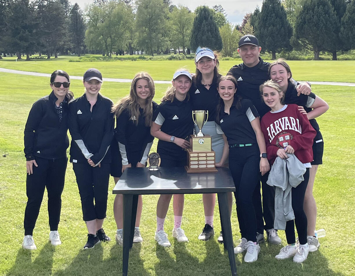 Woodland girls golf team poses with the 2A district trophy after their victory on Tuesday, May 17, 2022 at Mint Valley Golf Course in Longview.